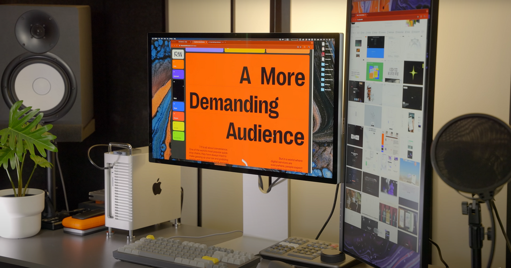 A professional workstation featuring a Mac Studio and dual monitors in a bright office.