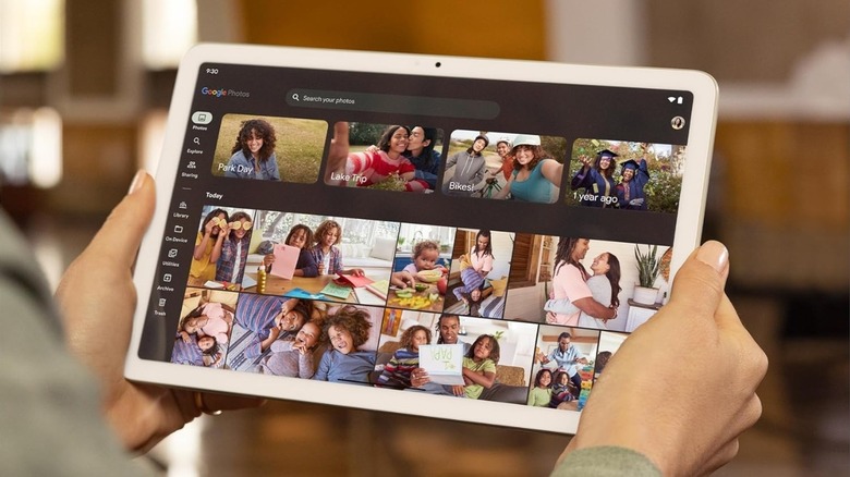 A user interacting with the Photos app on a Google Pixel Tablet.