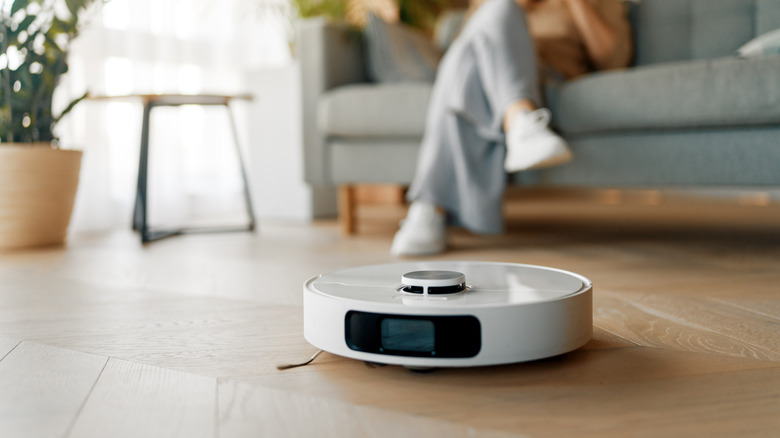 A robot vacuum cleaner navigating a living room floor while mapping the space.