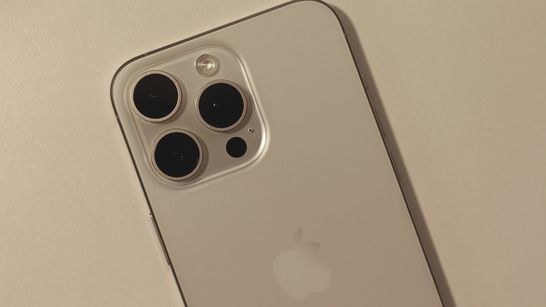 Close up shot of the iPhone Pro camera module highlighting the lenses and the black LiDAR sensor circle.
