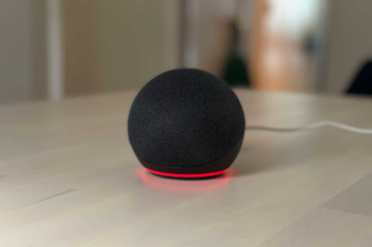 Close-up of an Amazon Echo with a solid red light ring indicating the microphone is muted.