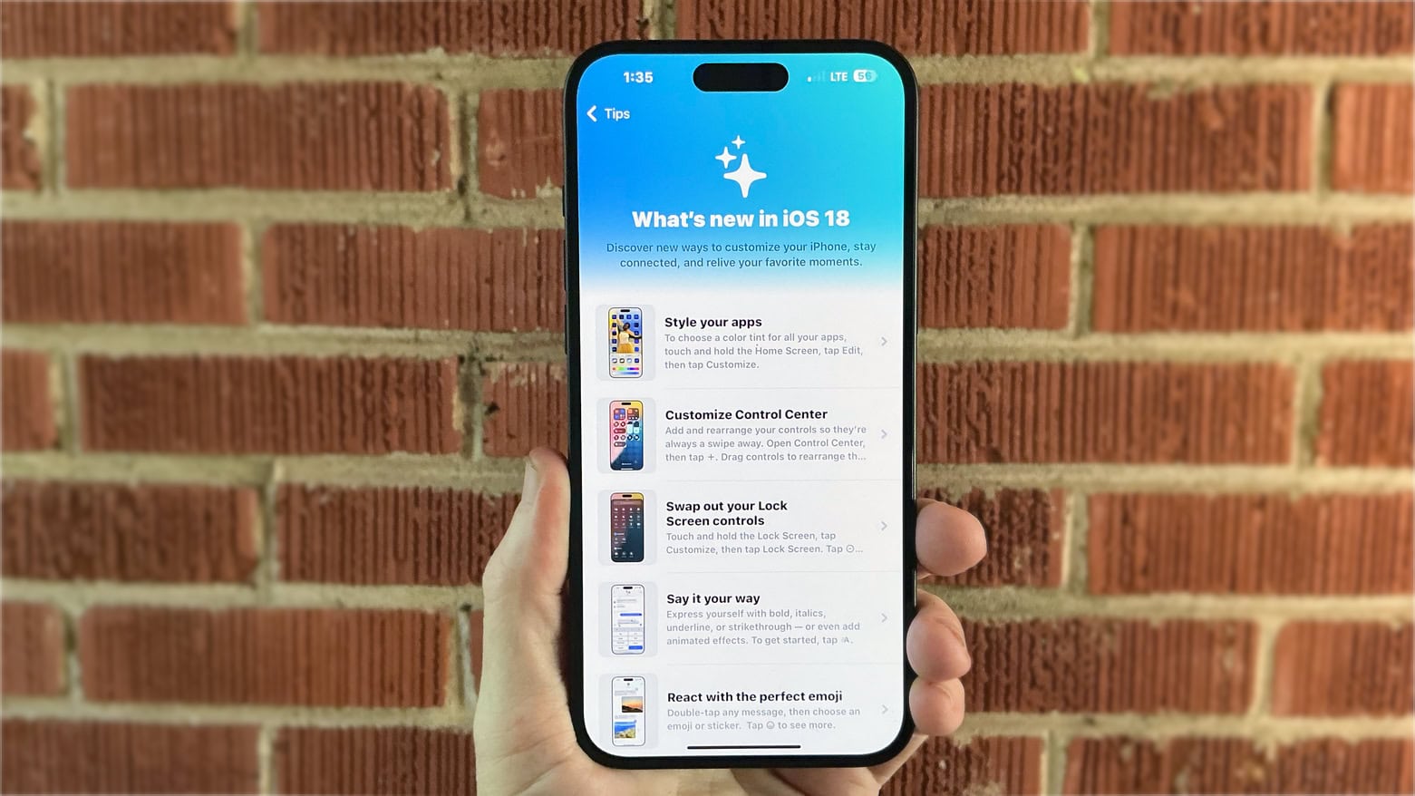 Handheld view of an iPhone 16 display highlighting its high brightness and Dynamic Island.