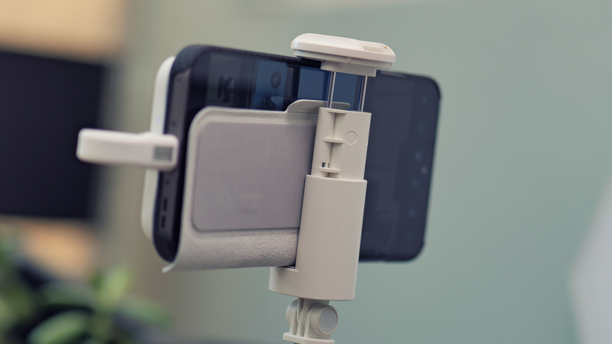 Back view of a smartphone and Insta360 Snap Selfie Screen assembly showing the rear cameras.