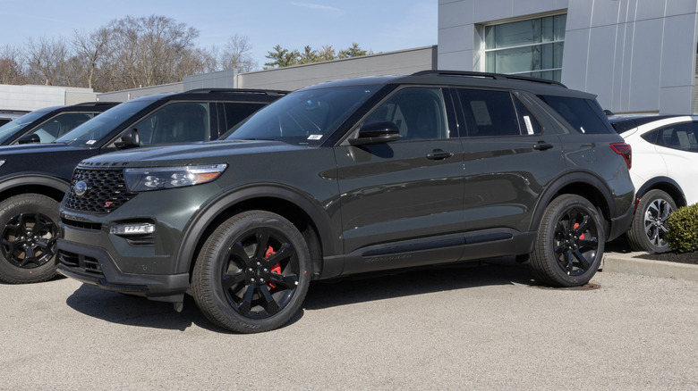 A black Ford Explorer ST parked at a dealership lot.