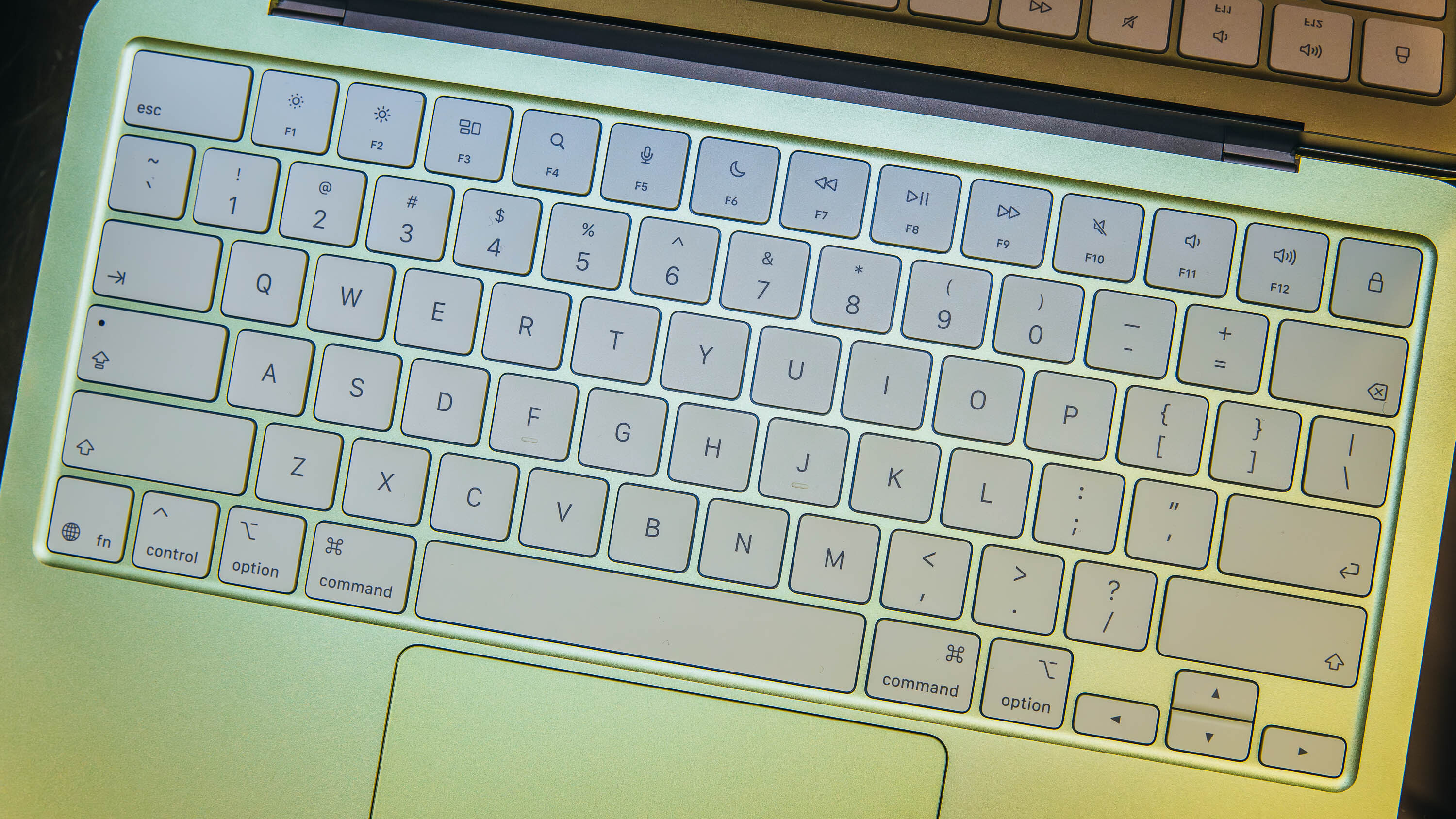 Close-up of the MacBook Neo keyboard and trackpad area.
