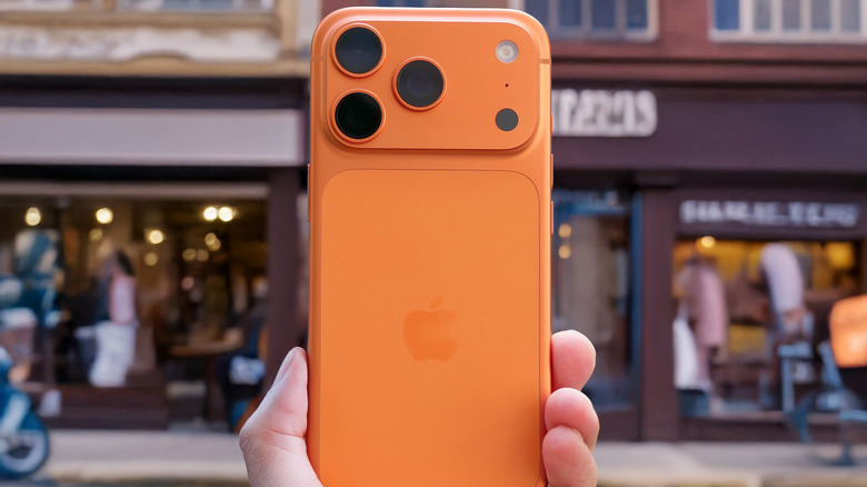 A person holding a well-maintained iPhone 17 Pro, showing its clean screen and body.