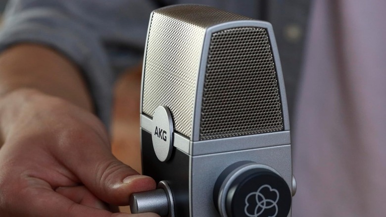 The silver AKG Pro Audio Lyra USB microphone on a sleek metal stand.