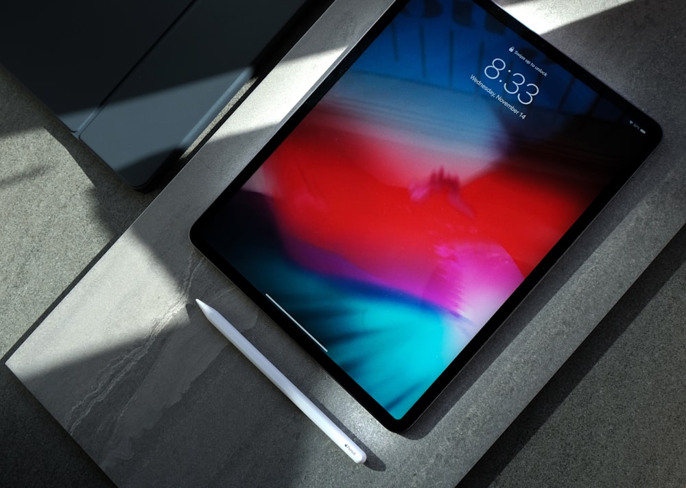 A person using an Apple Pencil to draw a digital illustration on an iPad screen.