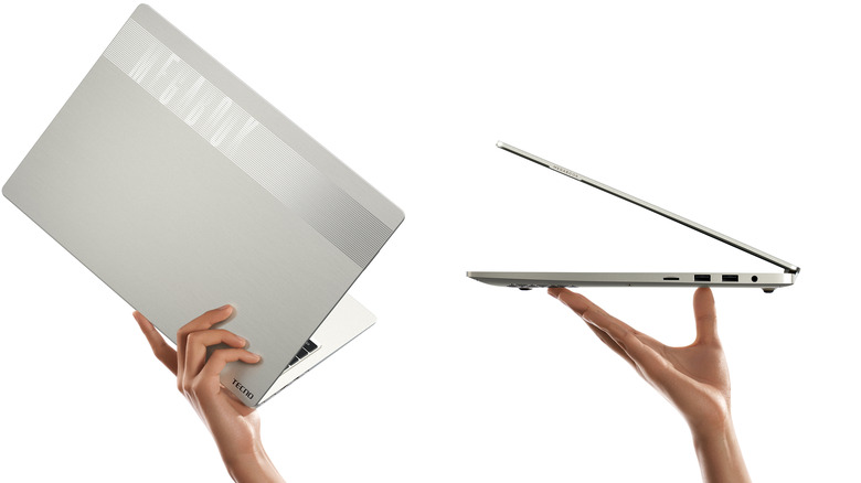 A person holding the Tecno Megabook T16 Pro, showcasing its 16-inch form factor.