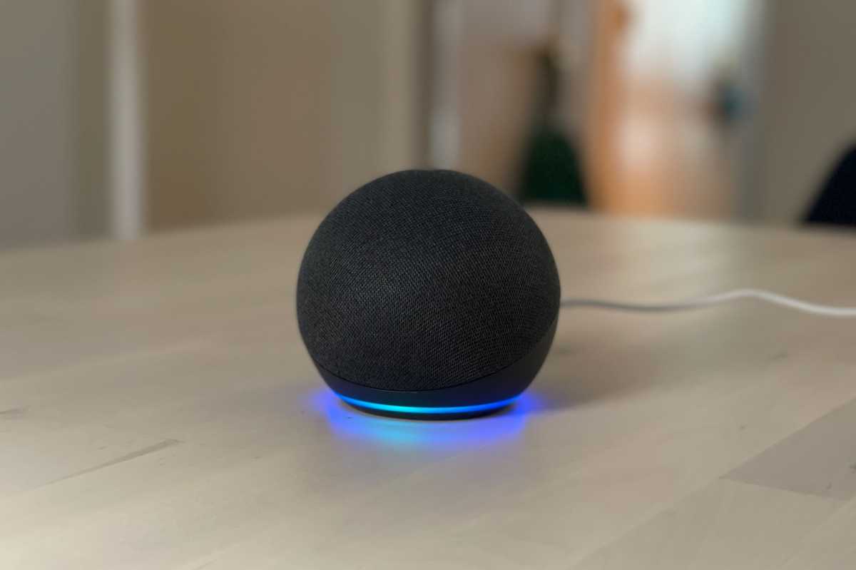 Amazon Echo speaker with a spinning blue and cyan light ring.