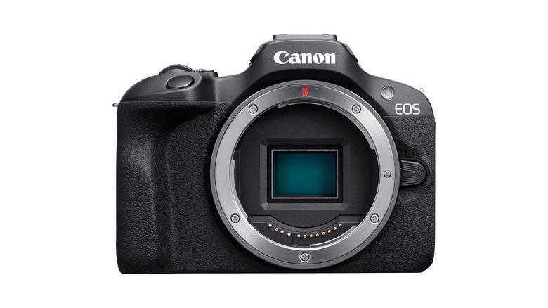 Front view of a compact Canon EOS R100 mirrorless camera.