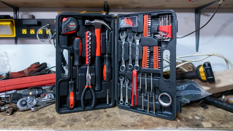 The Cartman household tool kit open on a white work table.