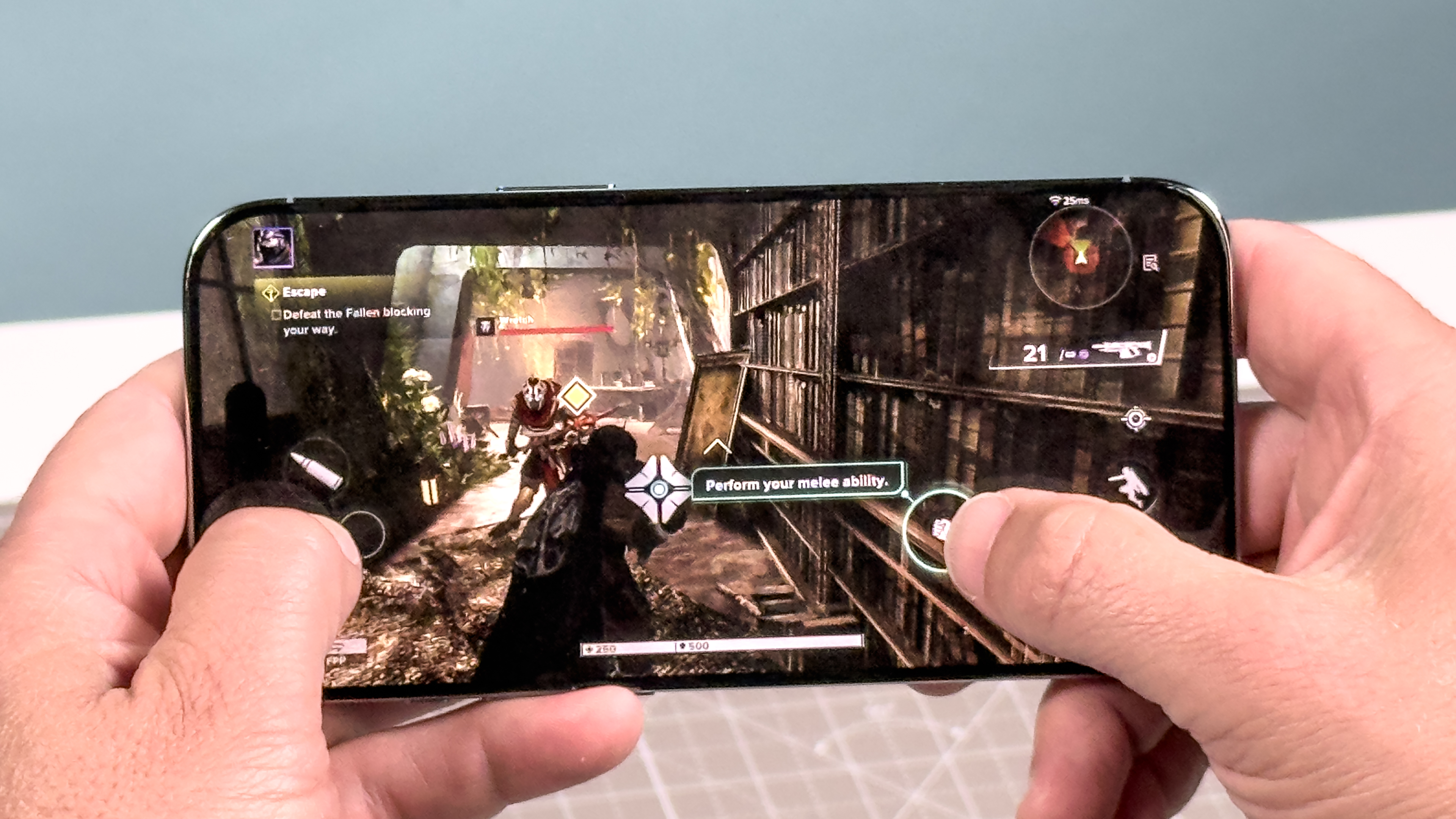 Hand holding an iPhone Air while playing a high-intensity mobile game.