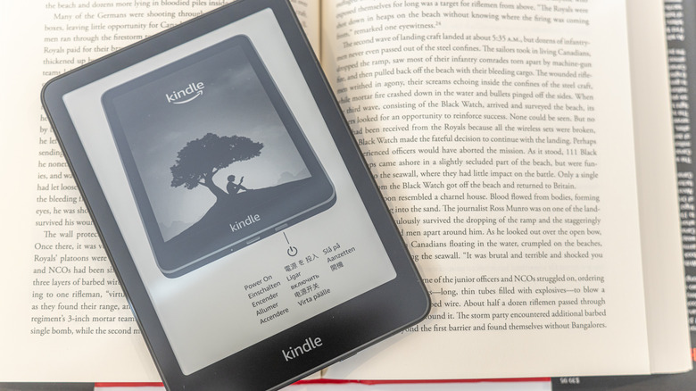 Amazon Kindle Paperwhite placed on top of a physical book.