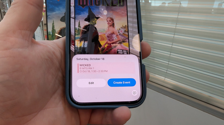 Close-up of the iPhone 17 screen showing a calendar app interface with Apple Intelligence features.