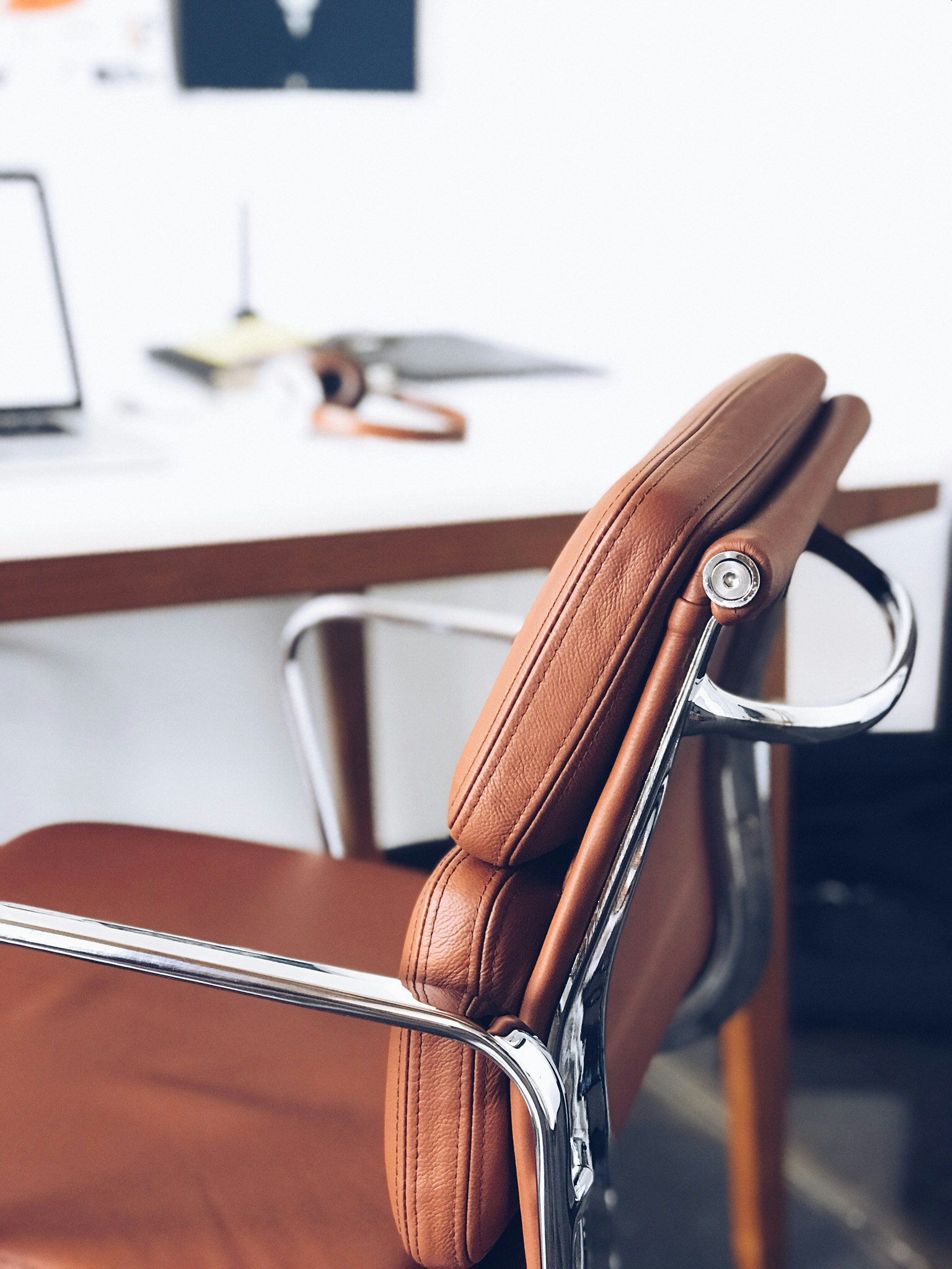 A high-tech ergonomic office chair with a skeleton-like backrest for dynamic movement support.
