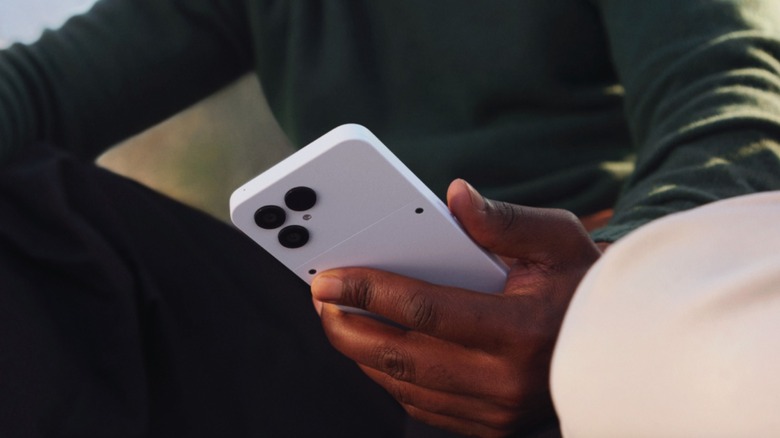 A person holding the Fairphone 6, highlighting its modular and eco-friendly build.