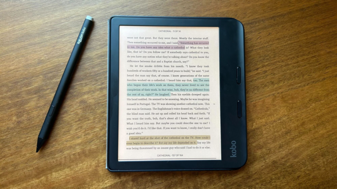 A Kobo Libra Colour device shown on a wooden surface highlighting its asymmetrical grip.