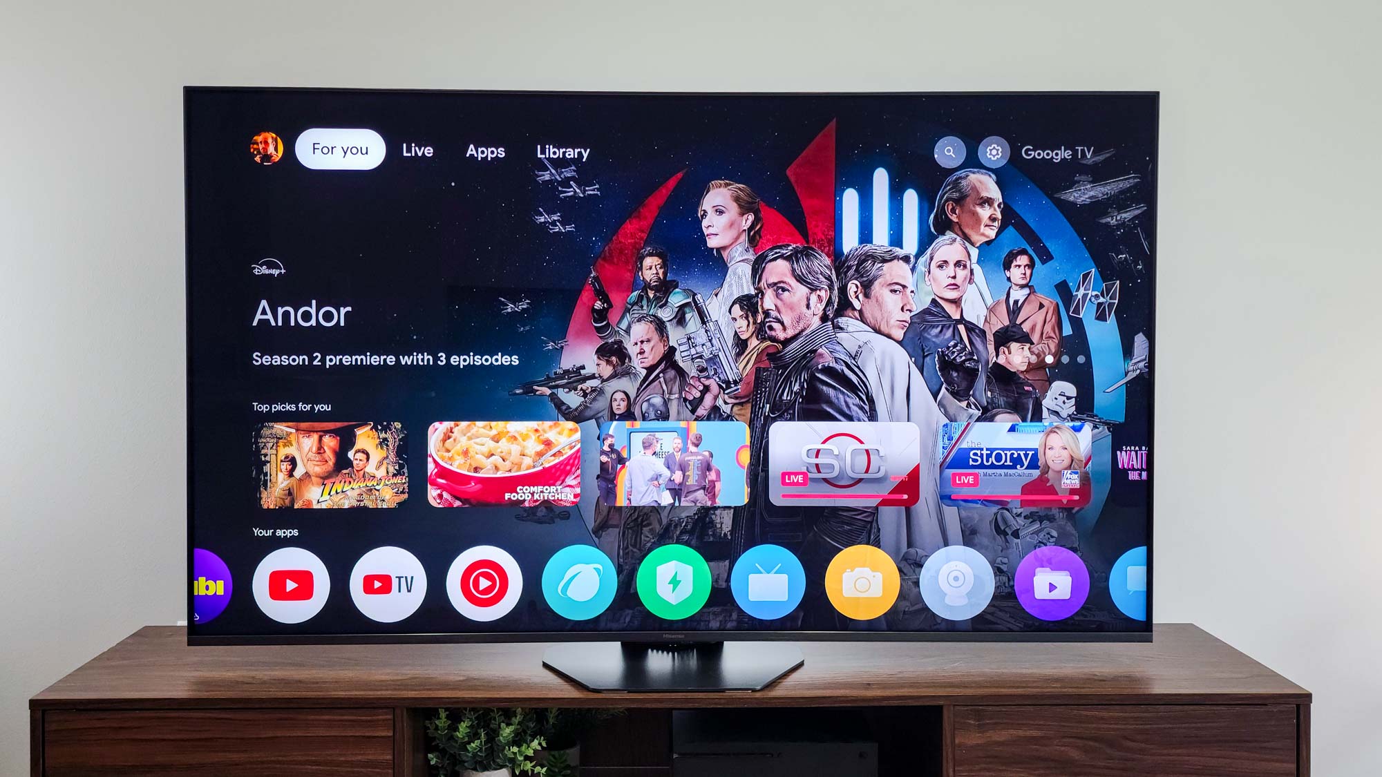 A Hisense U8QG Mini-LED TV displaying the Google TV home screen interface.
