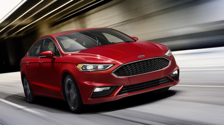 A dark 2017 Ford Fusion Sport driving through a modern tunnel.
