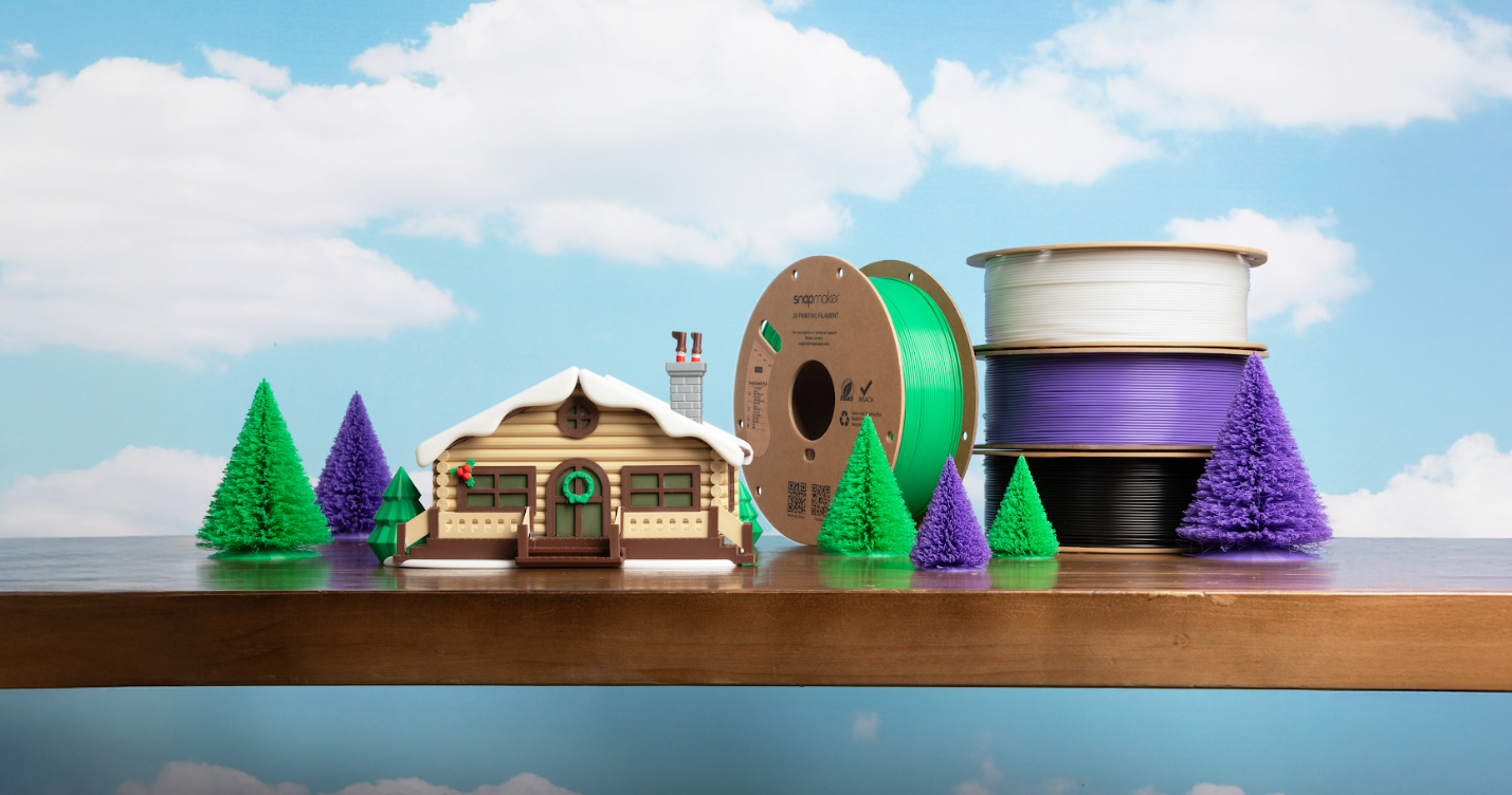 Close-up of a 3D printed log cabin model showing smooth surface finish and fine detail.