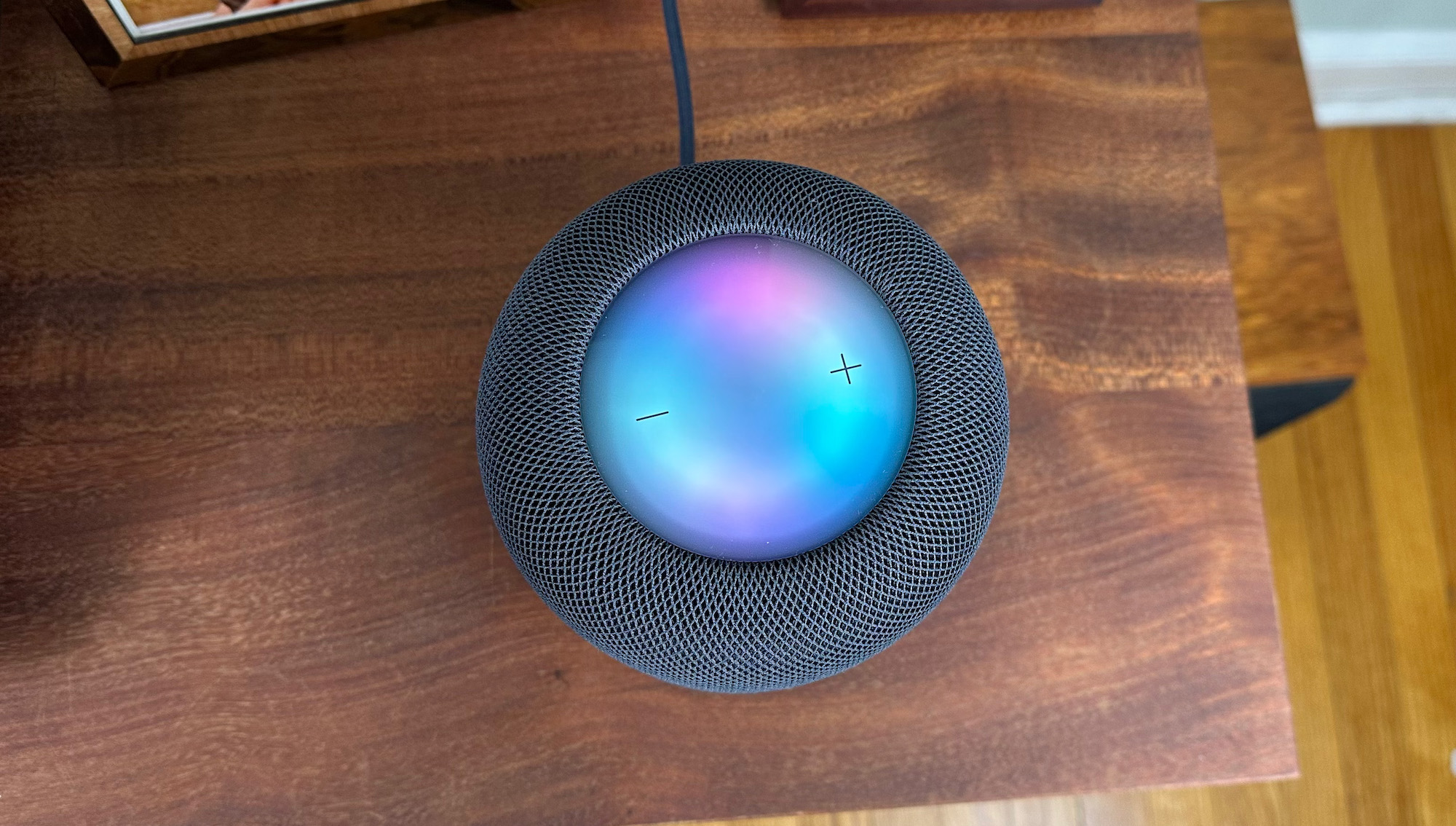 Top-down view of an Apple HomePod 2nd Generation with its colorful glowing touch interface.