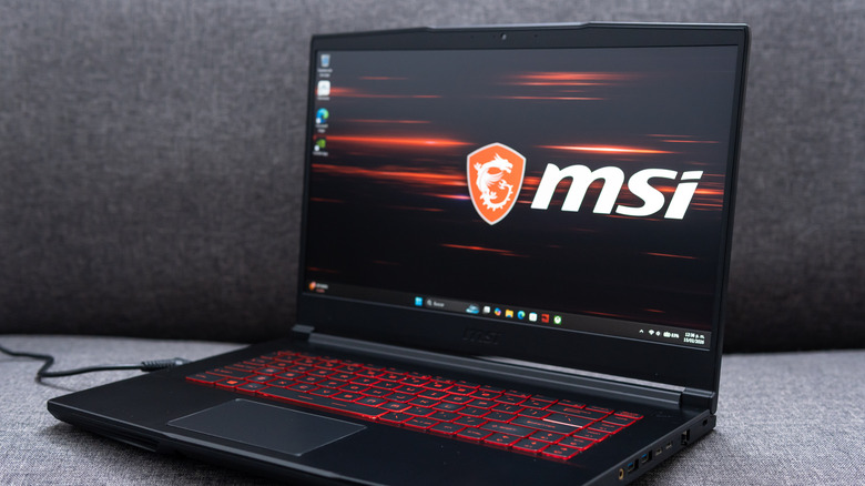 An open MSI gaming laptop showing the brand logo on the screen.