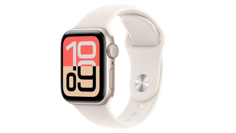 The Apple Watch SE 3 with a Starlight colored sport band on a plain background.