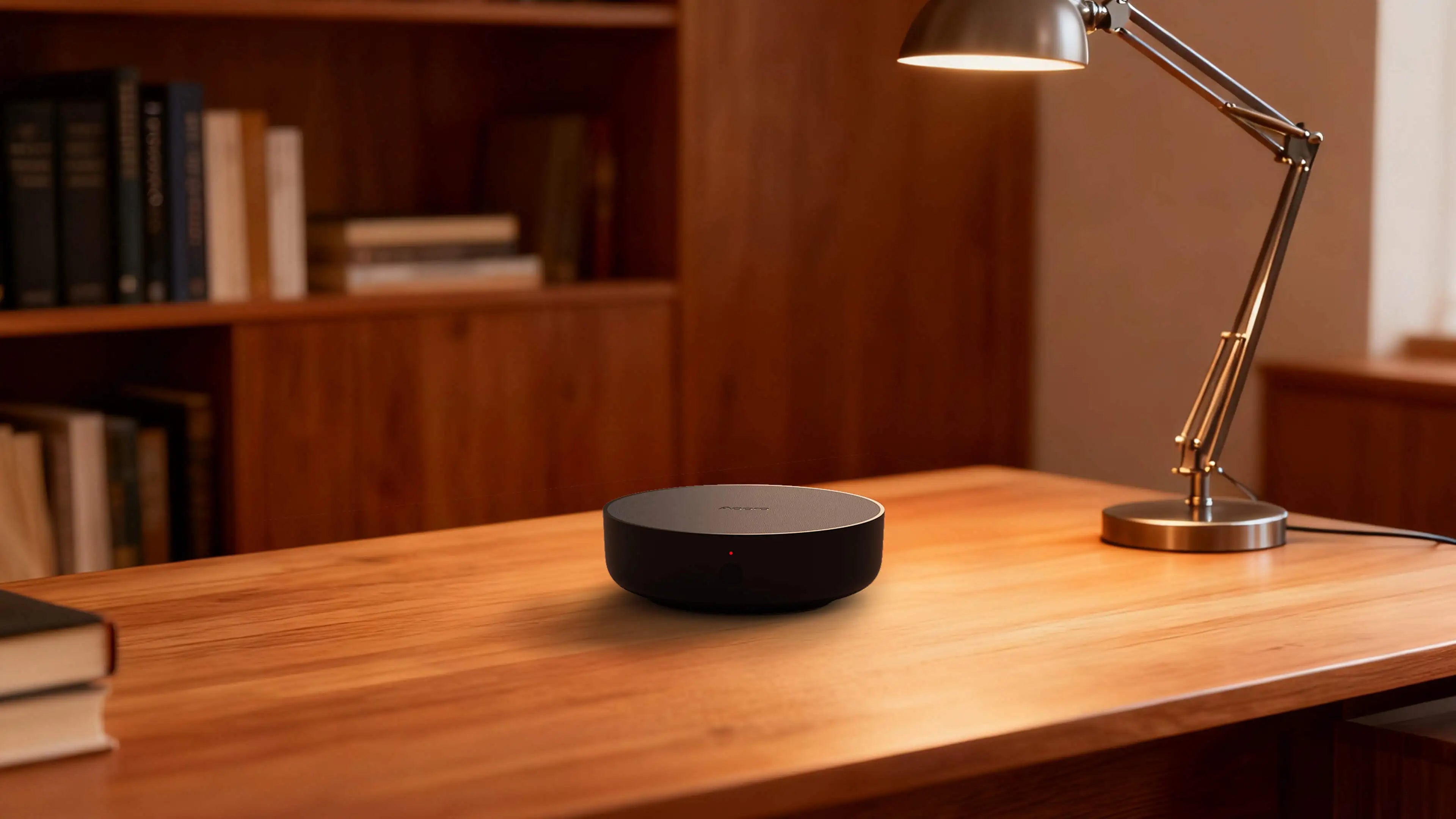 Aqara Hub M200 on a wooden table next to a desk lamp, acting as a Matter bridge.