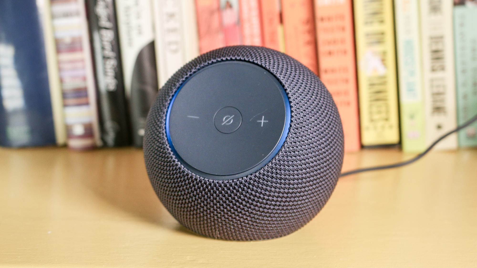 An Amazon Echo Dot Max smart speaker sitting neatly on a white bookshelf.