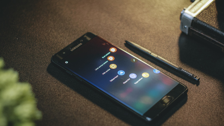Close-up of a Samsung Galaxy smartphone being used with its S-Pen stylus on the flat screen.