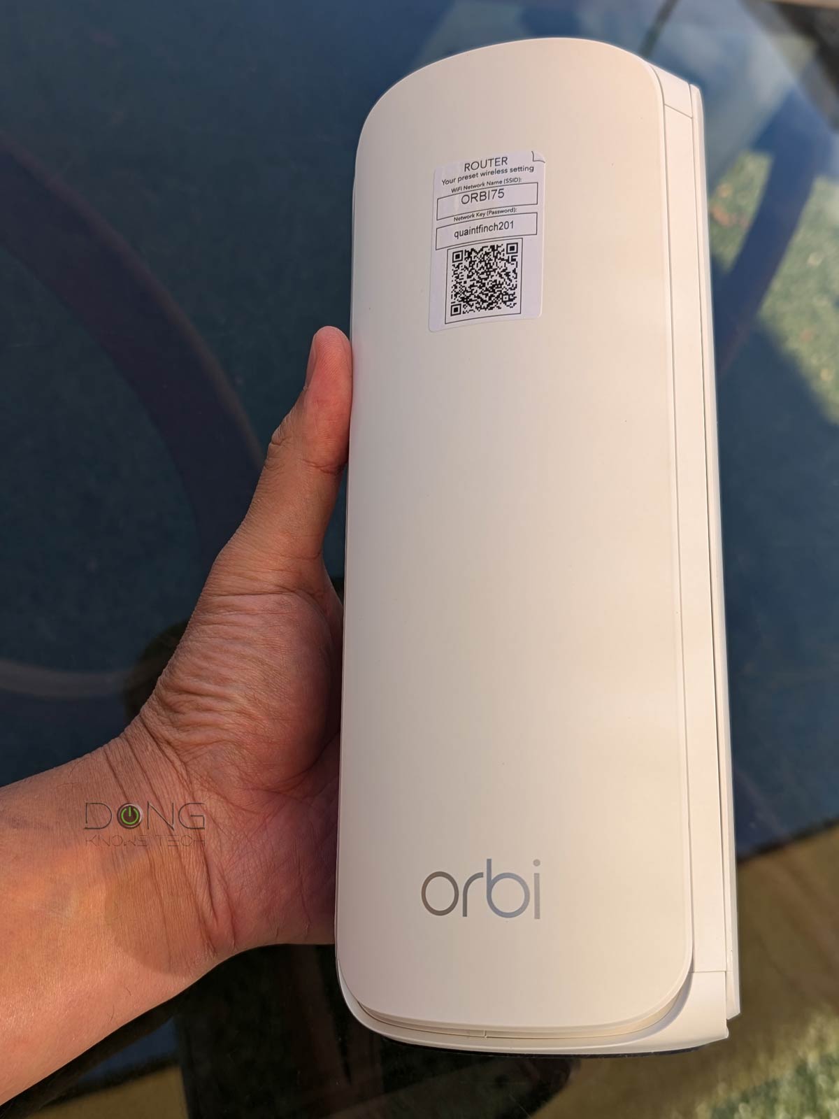 Front view of a single Netgear Orbi RBE771 router unit with a minimalist white design.