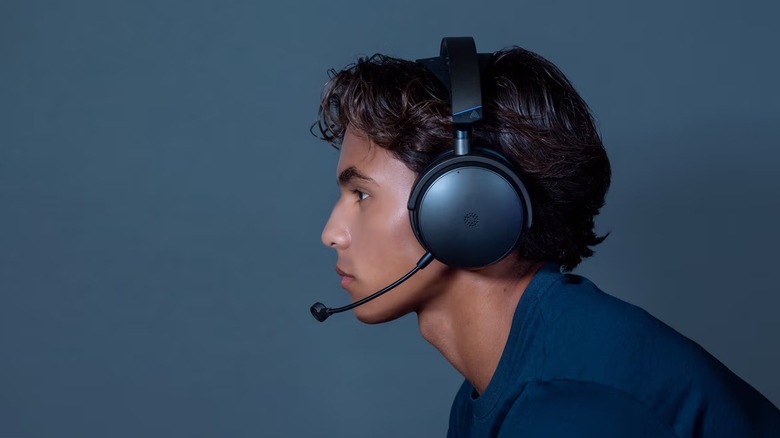 A person wearing the Audeze Maxwell 2 planar magnetic headphones.