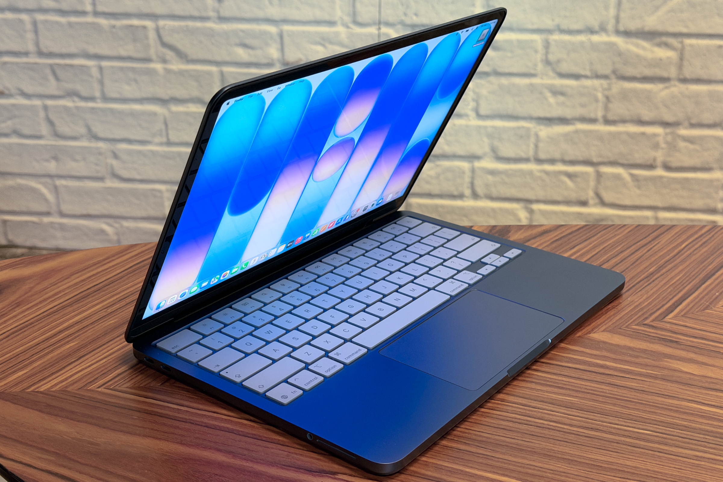 A front-facing view of the Apple MacBook Neo budget laptop on a desk.