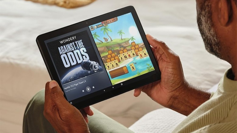 A person comfortably holding an Amazon Fire HD 10 tablet.