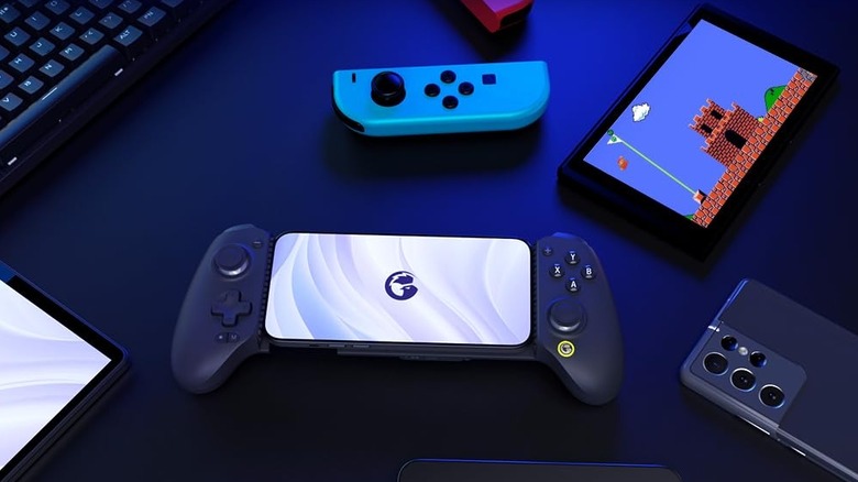 GameSir G8 Plus controller housing a smartphone, flanked by a Nintendo Switch and other handheld devices.
