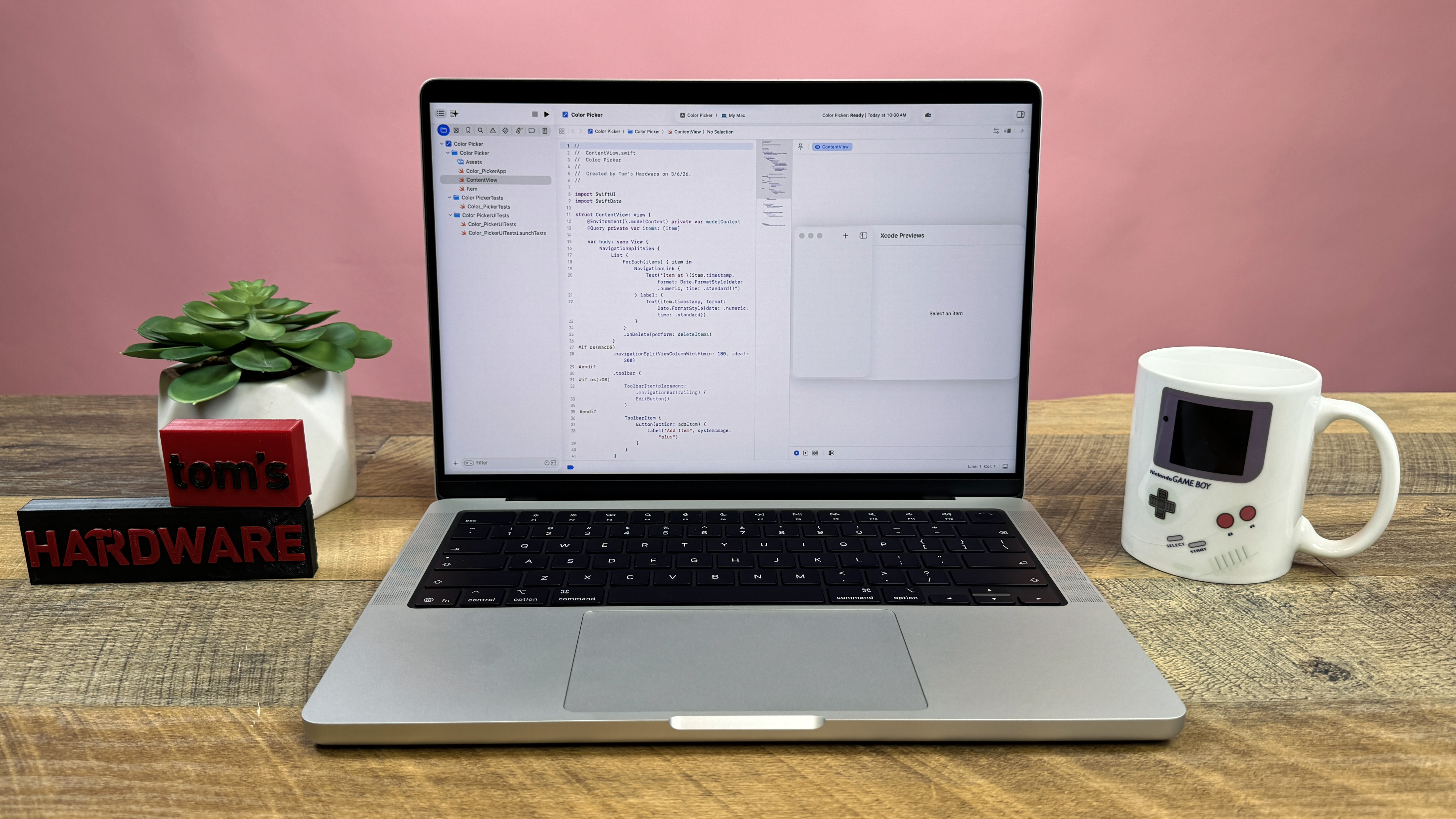A MacBook Pro 14 M5 Max integrated into a clean, professional desk setup with a monitor.