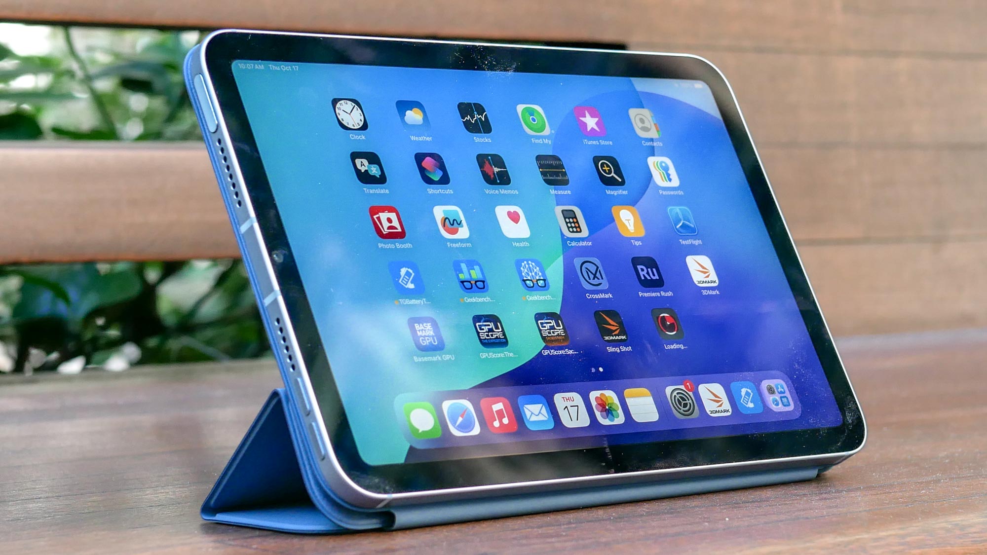 The compact iPad mini held comfortably in one hand to demonstrate its portable size.