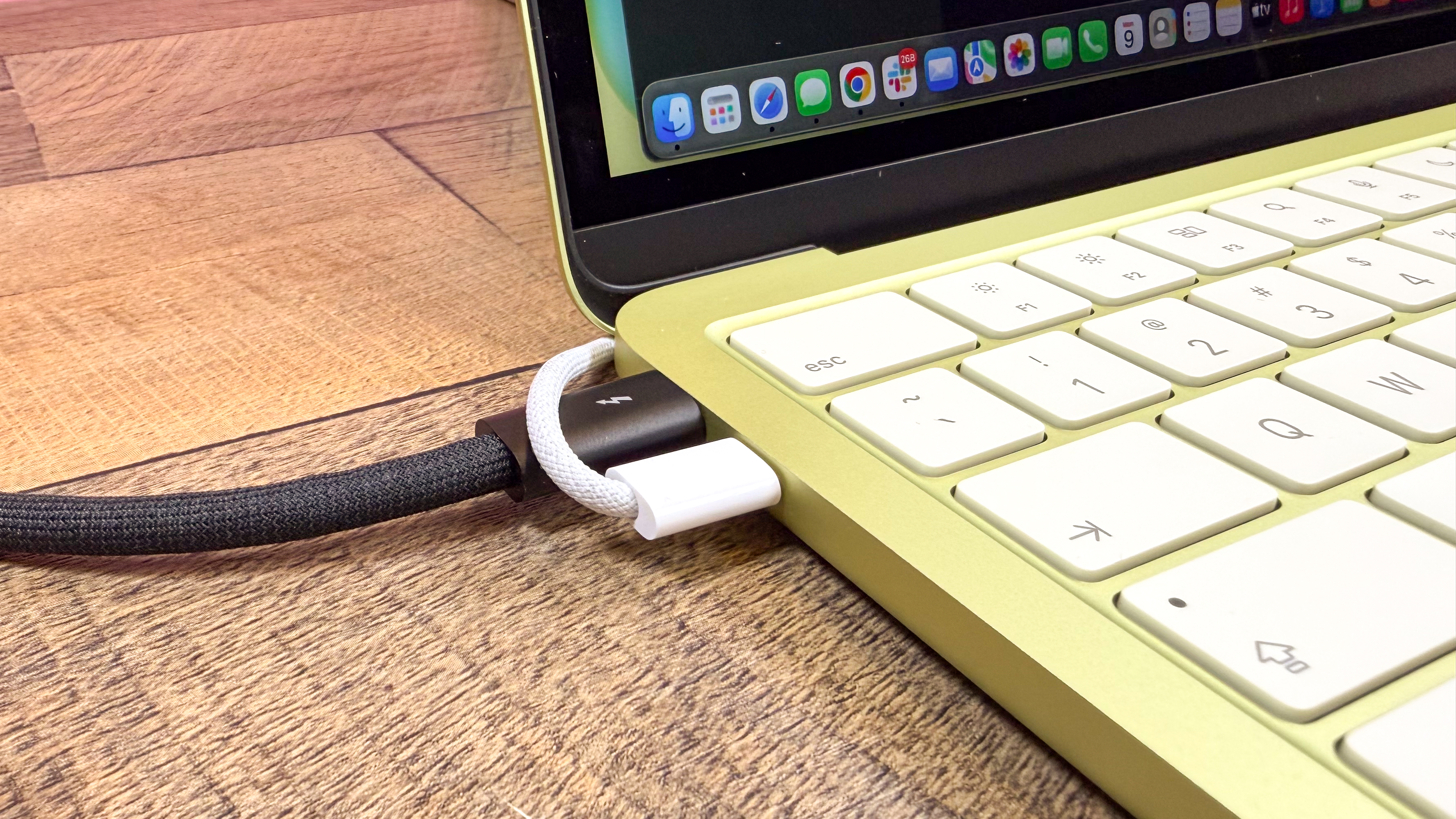 Close-up of the two USB-C ports on the side of the MacBook Neo.