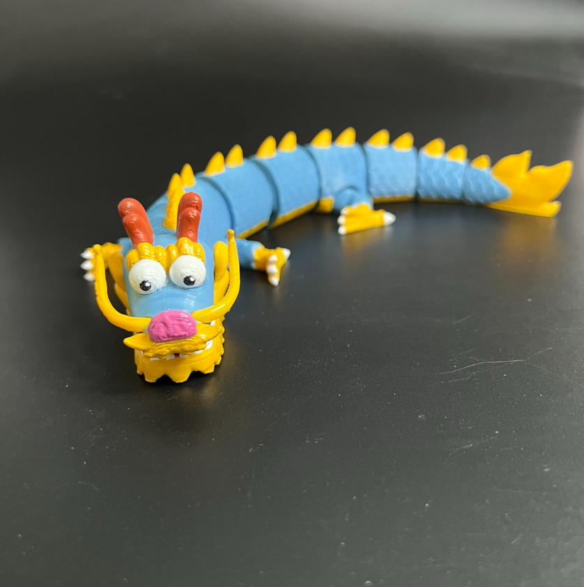 A highly detailed, flexible 3D printed dragon with articulated joints.
