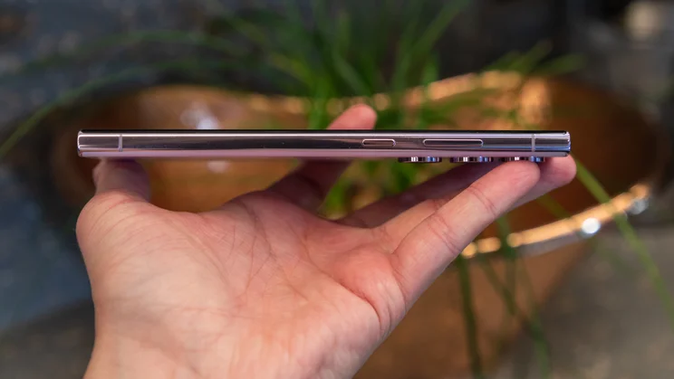 A hand using the S Pen to interact with the screen of a Samsung Galaxy S23 Ultra.